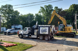 Several Culy Contracting trucks and equipment on job site